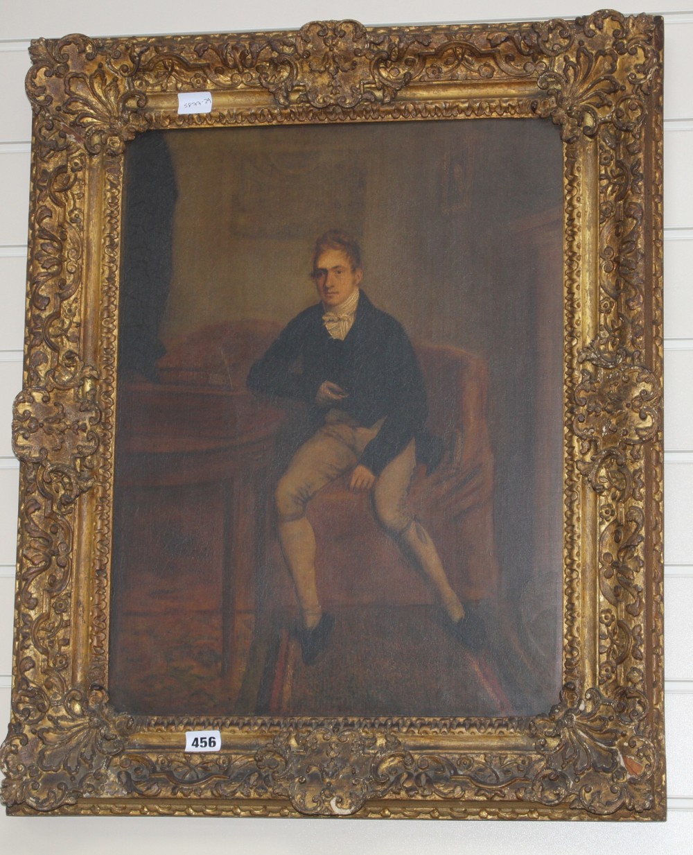 Early 19th century English School, oil on canvas, Full length portrait of a gentleman seated beside a writing slope, 53 x 40cm